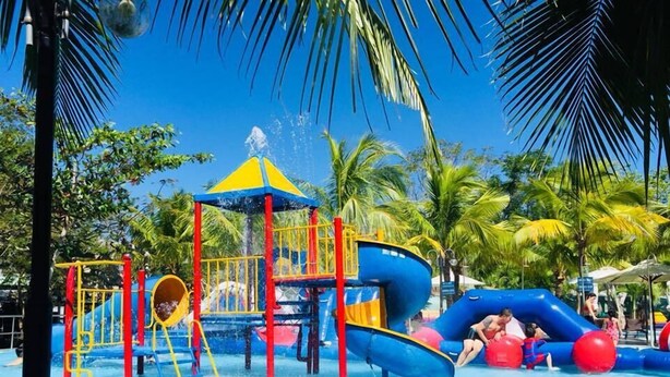 A water park with a blue and yellow play structure, including slides and a water play area. - Ho May Resort (Ho Chi Minh City)