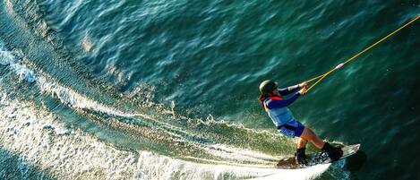 A person wakeboarding on a body of water.