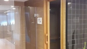 A modern hotel room with a glass door leading to a bathroom, a wooden door, and a tiled wall. - APARTMENT IN THE HEART MIRAFLORES (Miraflores)