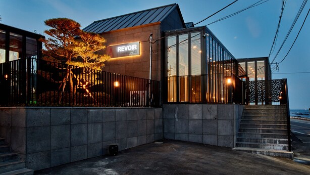 Een modern gebouw met een bord waarop 