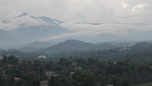 A mountainous landscape with a view of a valley and scattered buildings. - Mount view 11 (Kandy)