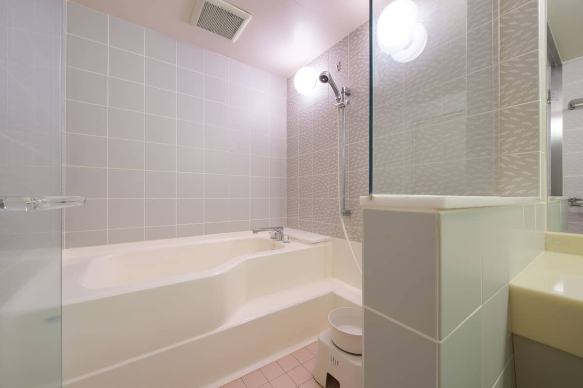 quadruple room - south tower | bathroom | separate bathtub and shower, free toiletries, hair dryer, slippers