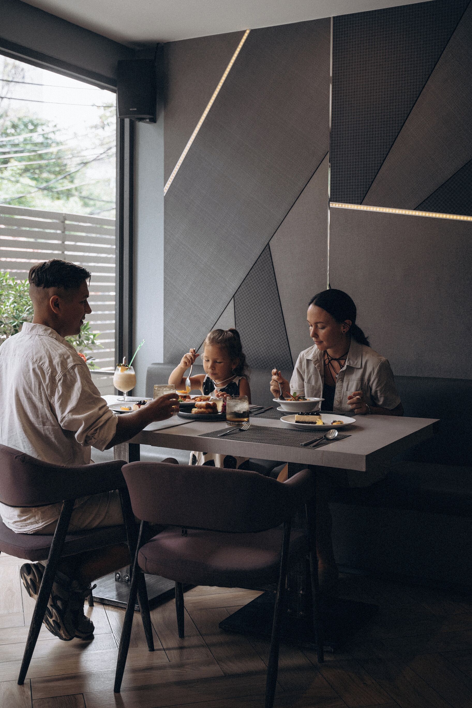 A modern dining area with a table, chairs, and a window.