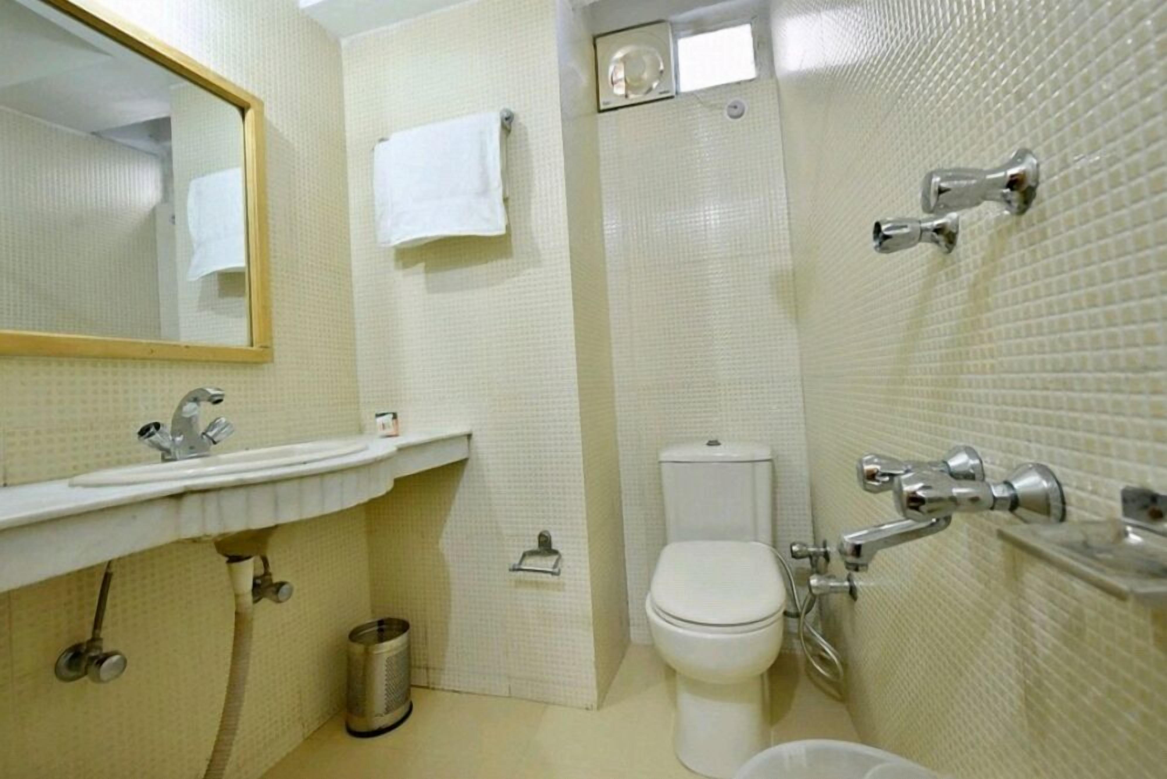 A bathroom with a sink, toilet, and shower.