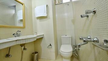 A bathroom with a sink, toilet, and shower.