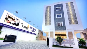 A modern hotel with a prominent 'Hotel Jump Booking Open' sign, a well-lit entrance, and a clean, contemporary design. - Hotel Jump In & Out (Coimbatore)