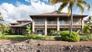 A large, two-story building with a traditional architectural style, featuring a balcony on the second floor. - Mauna Lani Private beach access, 2026 Hilton Waikoloa Pool pass included! (Waimea)