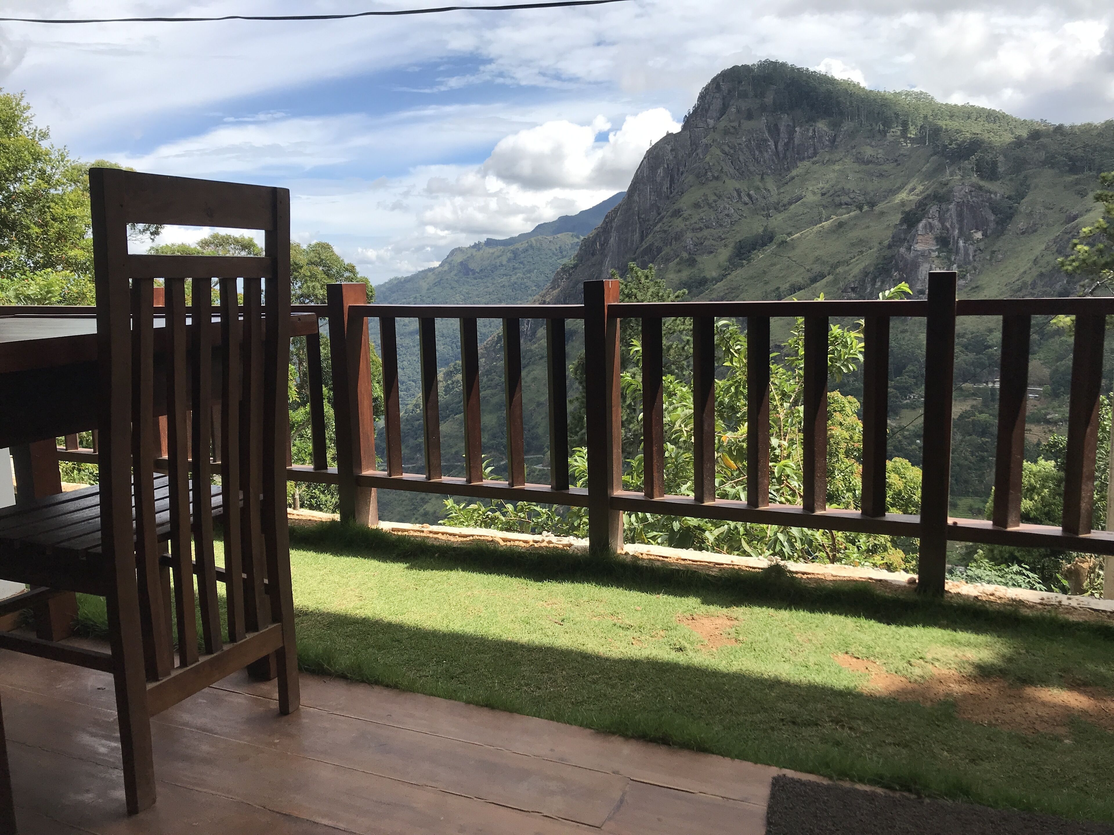 A wooden deck with a view of a mountainous landscape.