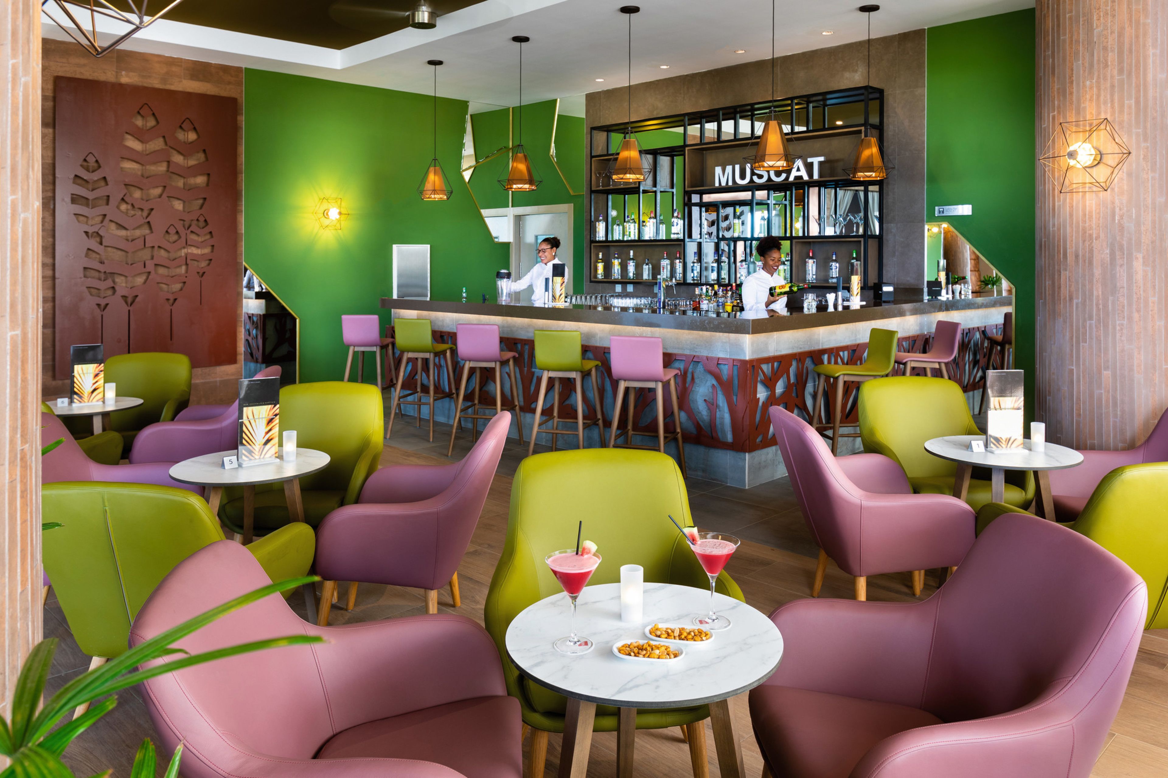 A modern bar area with colorful chairs and a bar counter.