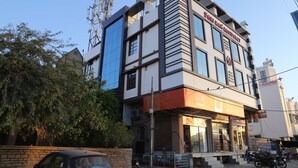 A multi-story building with a sign for 'Sham Ram Residency'.