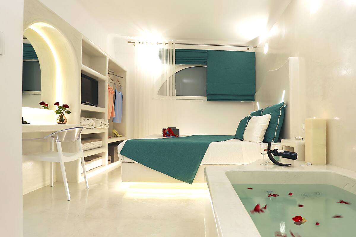 A modern bathroom with a bathtub, a vanity with a mirror, and a shower area.