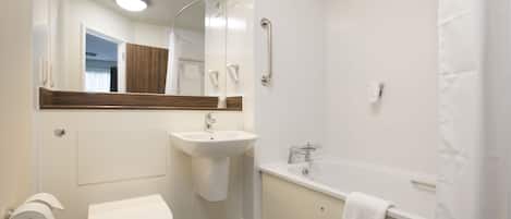 A modern bathroom with a toilet, sink, and bathtub.