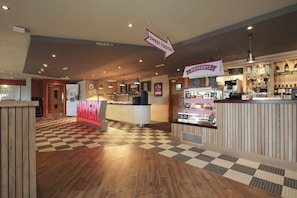 A restaurant with a checkered floor, a dessert counter, and a sign for 'Sweet Tooth?'. - Spring River Ebbsfleet by Marston's Inns (Gravesend)