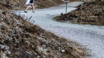 A gravel path with a person walking.