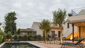 Een seizoensgebonden buitenzwembad en parasols bij het zwembad