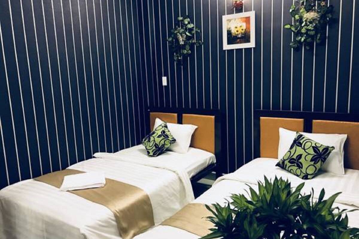Chambre Deluxe avec lits jumeaux | Bureau, fer et planche Ă repasser, Wi-Fi gratuit