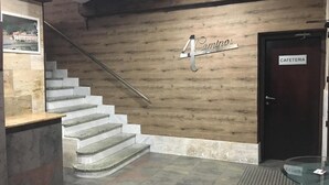 A staircase leading to a door labeled "CAFETERIA" with a sign above it reading "4 Caminos". - Hostal Restaurante Cuatro Caminos (Piedrabuena)