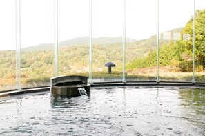 A hot spring area with a view of a forested hillside. - Hotel Windsor (Nakatsugawa)