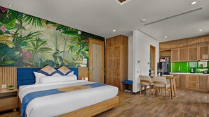 A modern room with a bed, a desk, and a kitchenette. - Animor Green Home Da Nang (Da Nang)