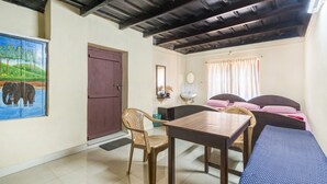 A room with a bed, a desk, a chair, a door, and a painting. - GuestHouser 4 BHK Homestay f531 (Devikolam)