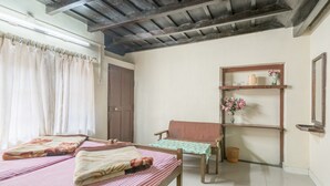 A room with a bed, a chair, a shelf with items, and a door. - GuestHouser 4 BHK Homestay f531 (Devikolam)