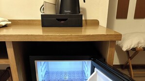 A compact refrigerator with a built-in coffee maker and a small shelf. - Hotel Ferrari (Pinzolo)