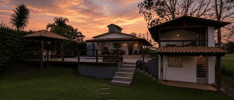 A villa with a swimming pool, outdoor seating, and a staircase leading to the main building.