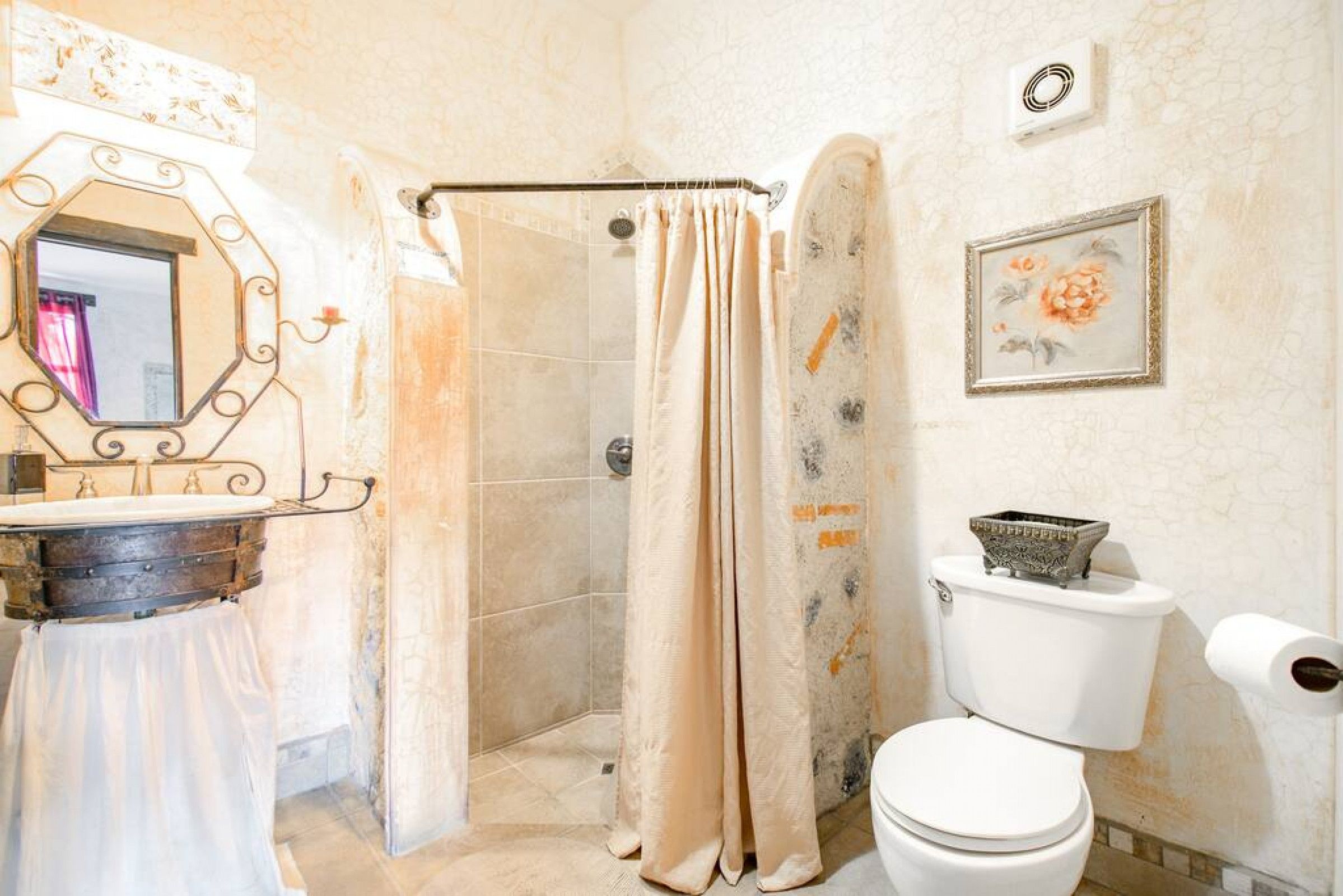 A bathroom with a shower, toilet, and sink.
