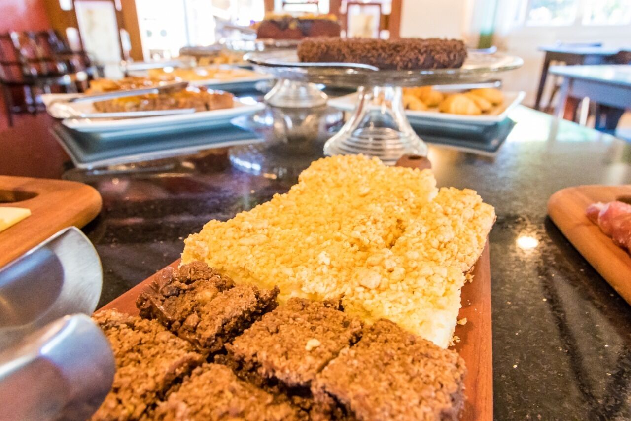A buffet table with various food items including brownies and a dish with a crumbly topping.