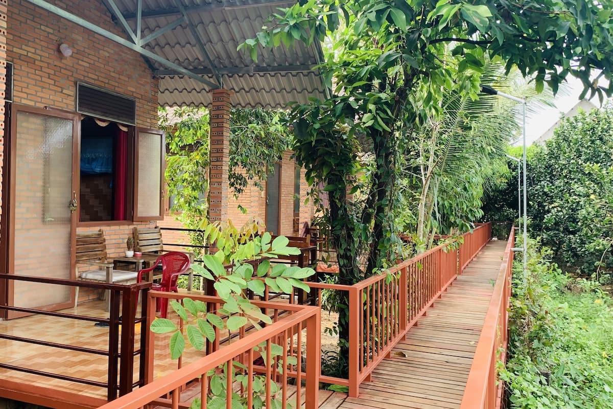 A brick building with a wooden deck and a metal railing.