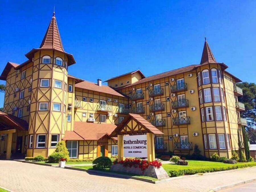 A large, multi-story building with a distinctive architectural style, featuring a central tower and multiple balconies.