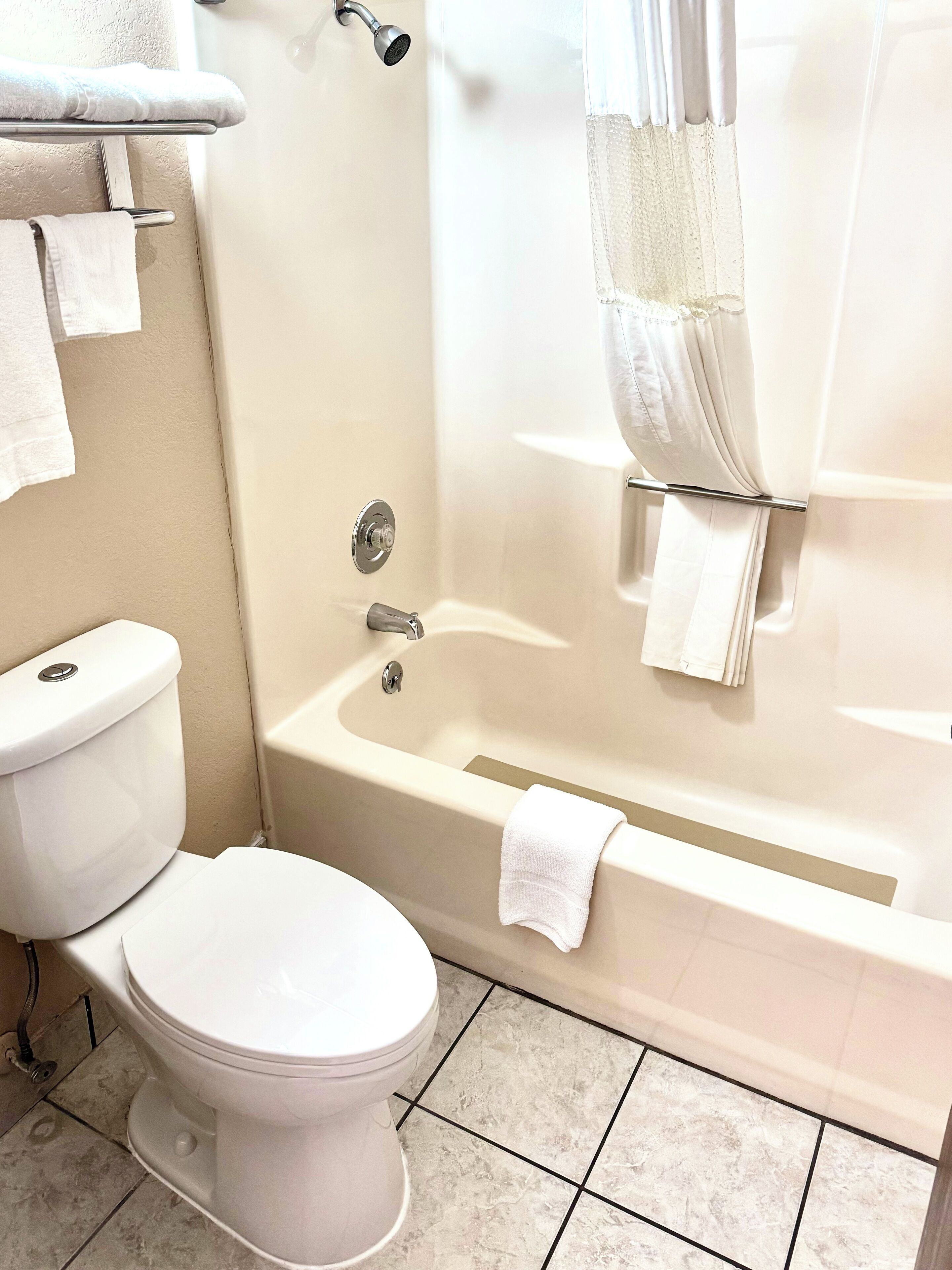 Separate bathtub and shower, rainfall showerhead, hair dryer, towels