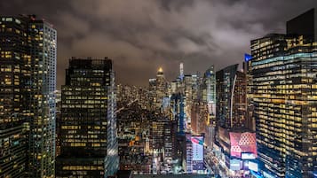 A nighttime cityscape with illuminated skyscrapers and a dense urban environment.