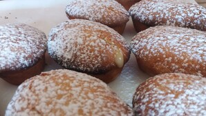 A tray of round pastries dusted with powdered sugar. - Gallipolis Terra (Gallipoli)