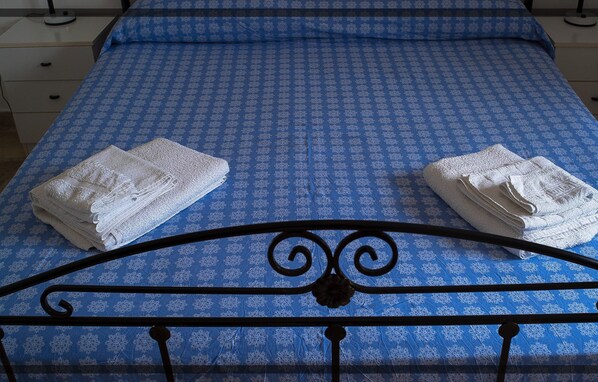 Restful retreat with a neatly made bed and plush towels.