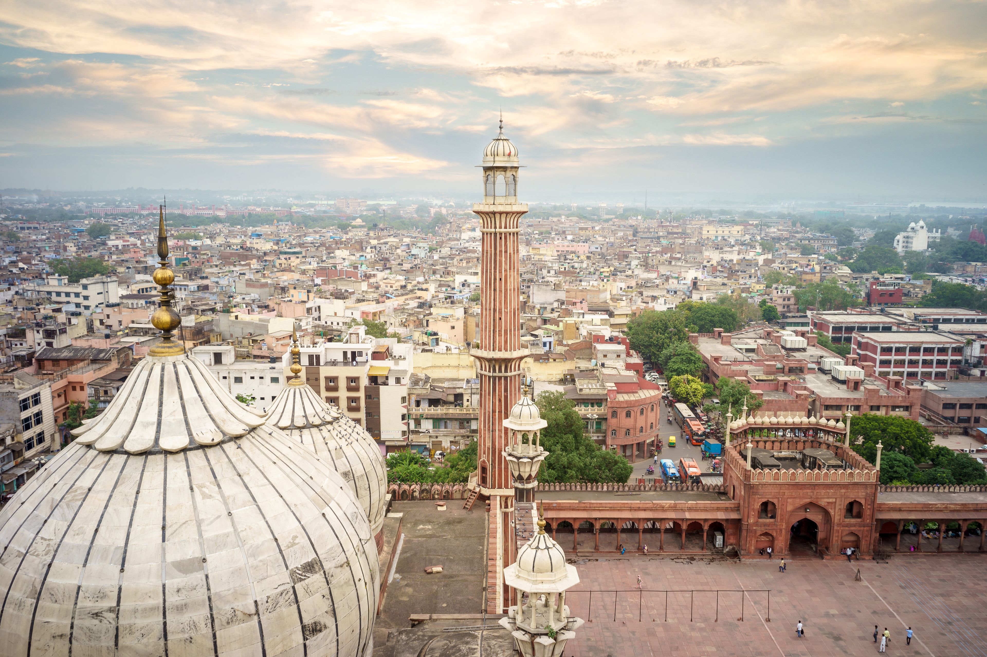 A large domed building with a minaret and a courtyard.