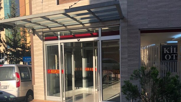 A modern hotel entrance with glass doors and a covered entrance area. - Kilim Otel (Sanliurfa)
