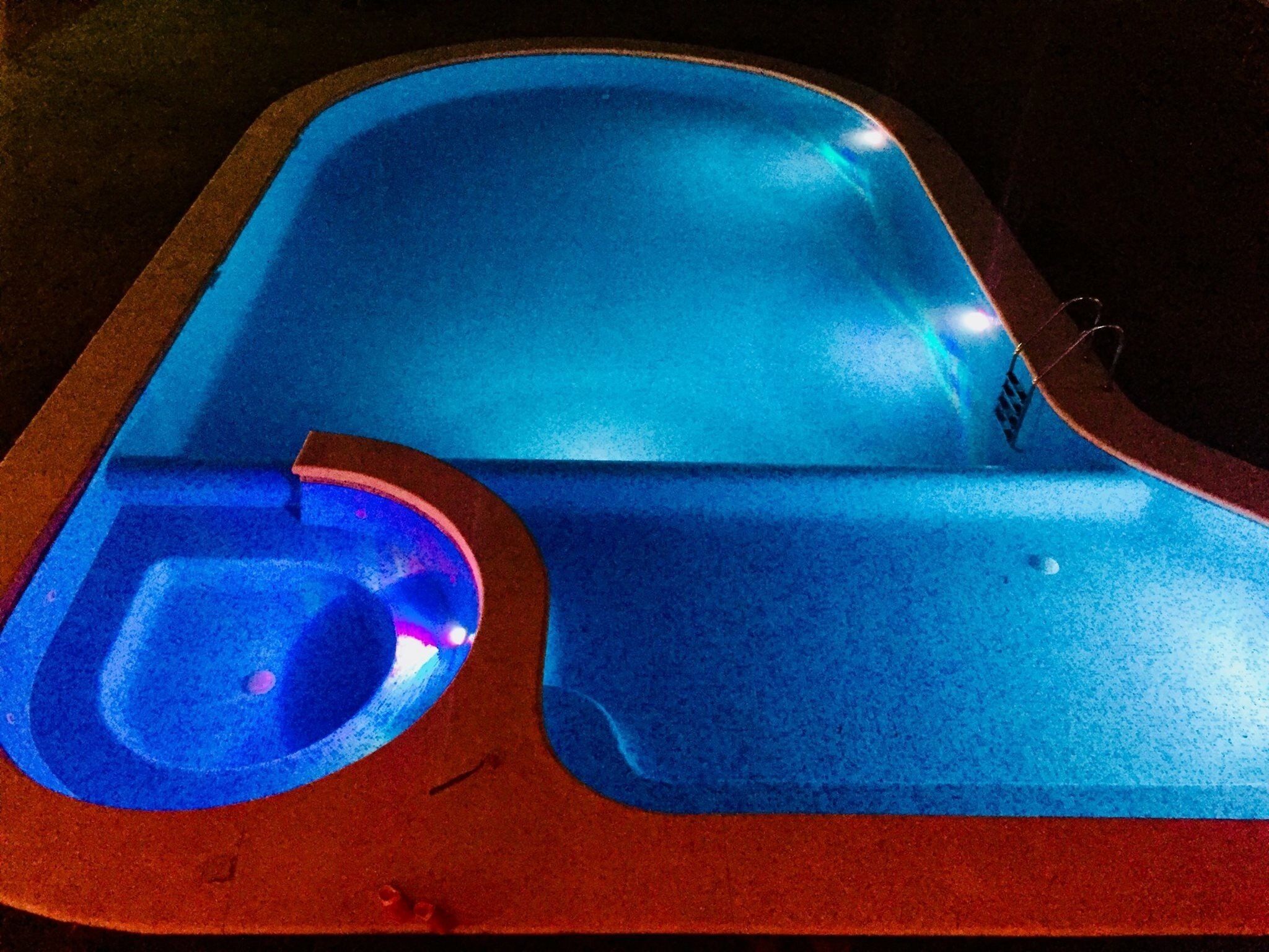 A swimming pool with a red border and a blue interior.