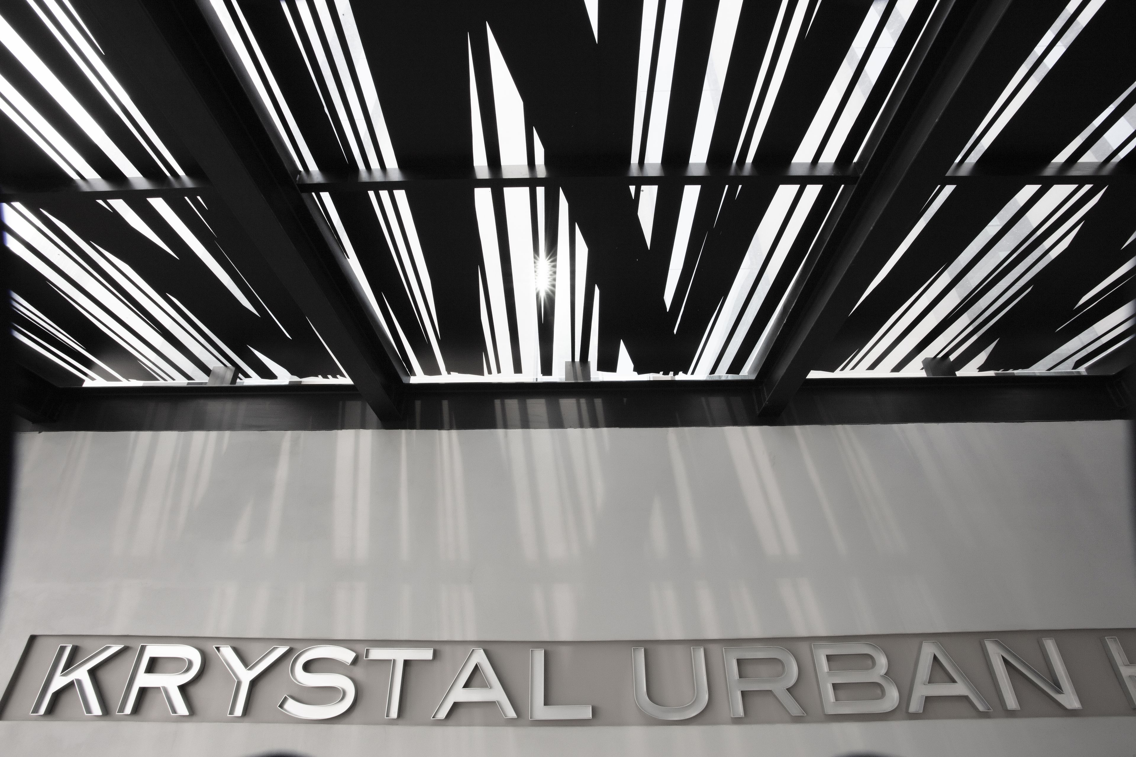 A modern building with a sign that reads "KRYSTAL URBAN".