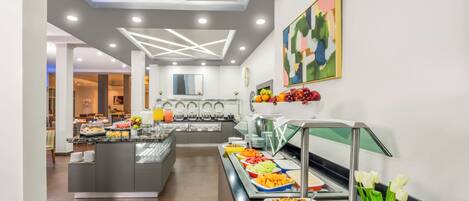 A modern hotel breakfast area with a central island, buffet with various food options, and a decorative wall piece.