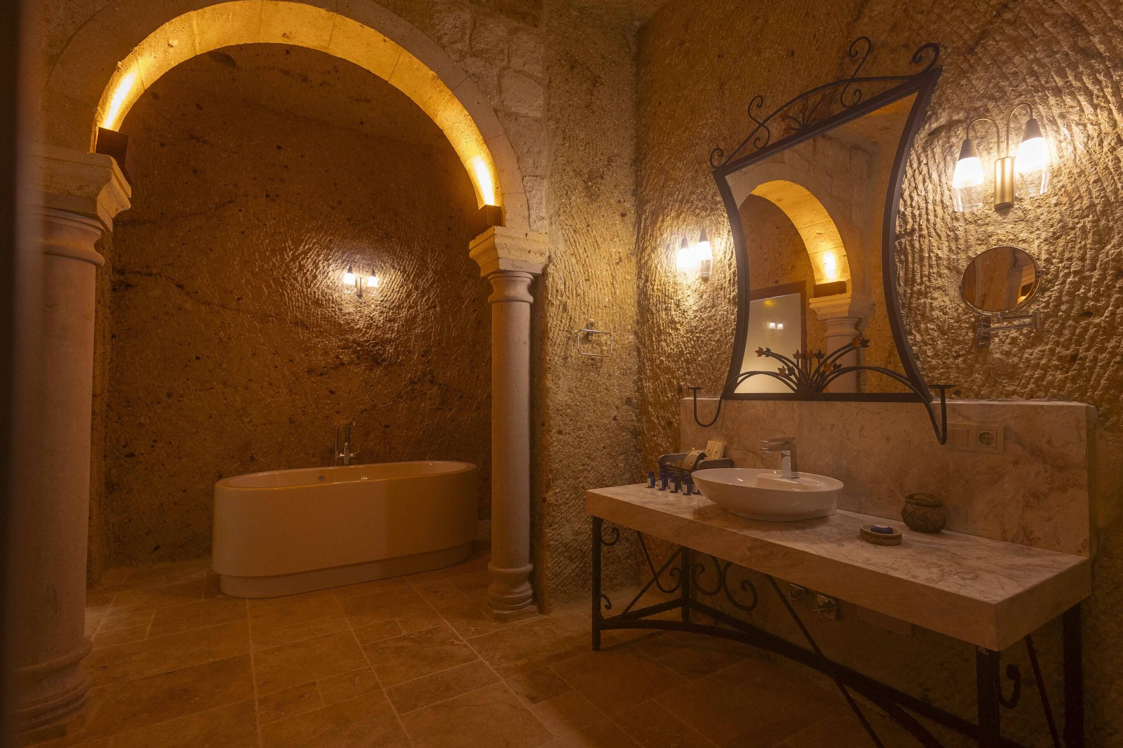 A bathroom with a bathtub, a sink, and a mirror.