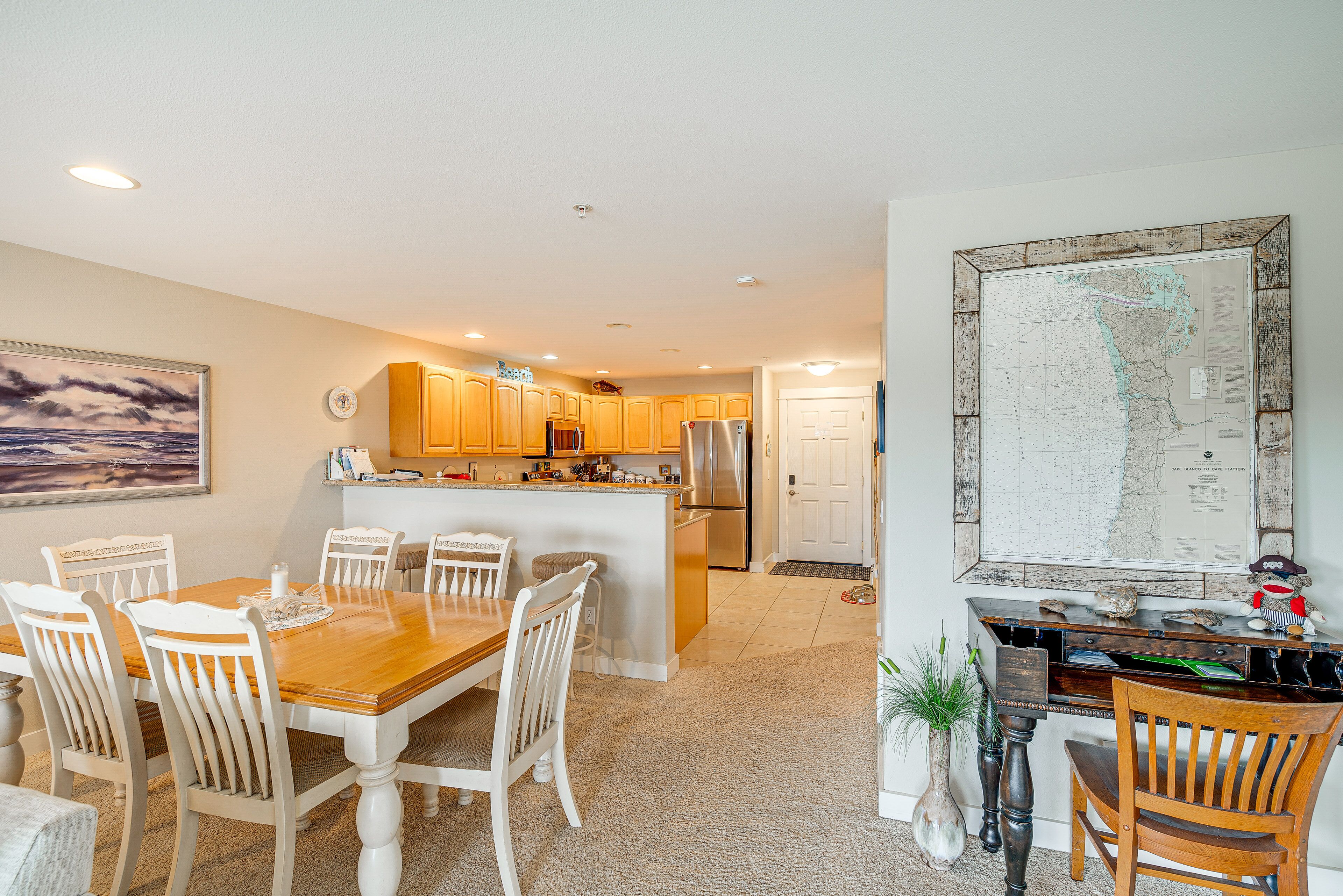 A spacious kitchen with wooden cabinets, a central island, and a dining area with a wooden table and chairs.