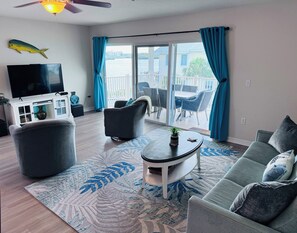 Relax in this stylish living room with a flat-screen TV, comfortable sofa, and a cozy coffee table.