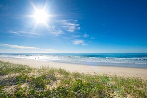 A beach with clear skies and sunlight.