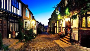 A cobblestone street lined with traditional buildings, some with signage indicating local businesses. - Rye Bay House -  a cottage that sleeps 8 guests  in 4 bedrooms (Rye)