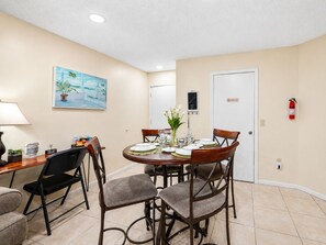 A dining area with a round table set for four, surrounded by chairs. - Colinas del Atlantico Vacational House 1st Floor (Isabela)