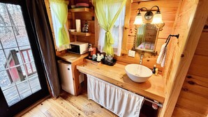 A wooden cabin bathroom with a sink, mirror, and shelves. - #15 Queenie - Gypsy Cottage (Sevierville)