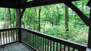 A wooden deck with a view of a dense forest. - #11 Mina - *New KitchenTiny Home Cottage (Sevierville)