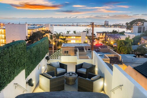 Relax, recharge and enjoy panoramic sunset views over the bay and ocean in this luxurious home