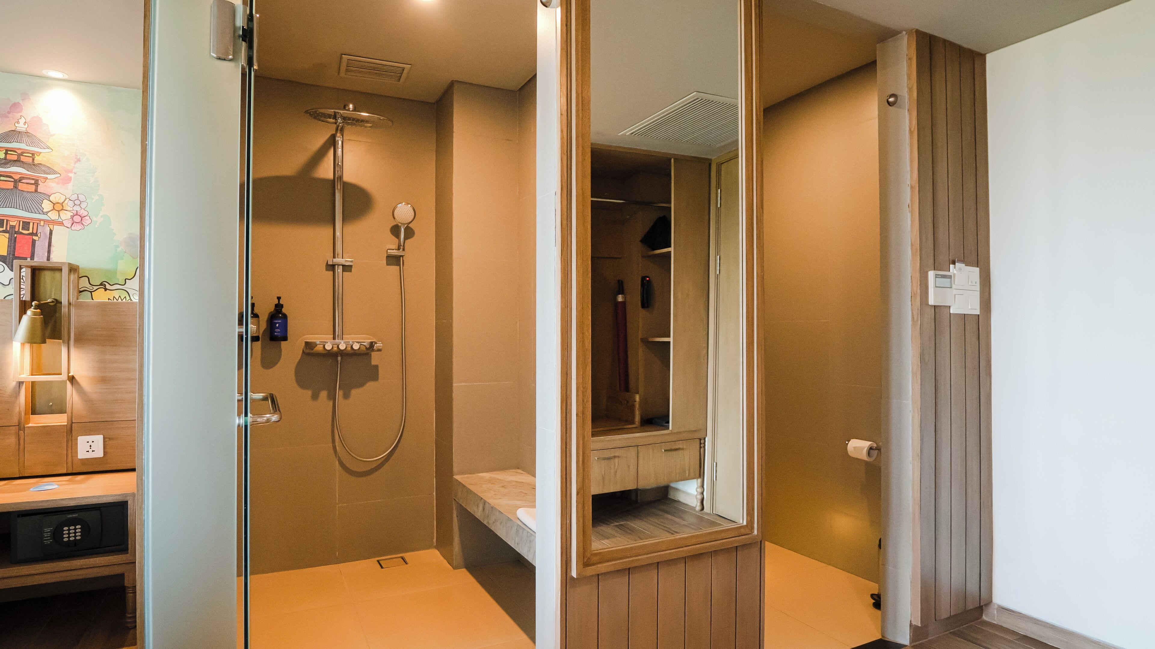 Un baño moderno con cabina de ducha, paneles de madera y un banco integrado.